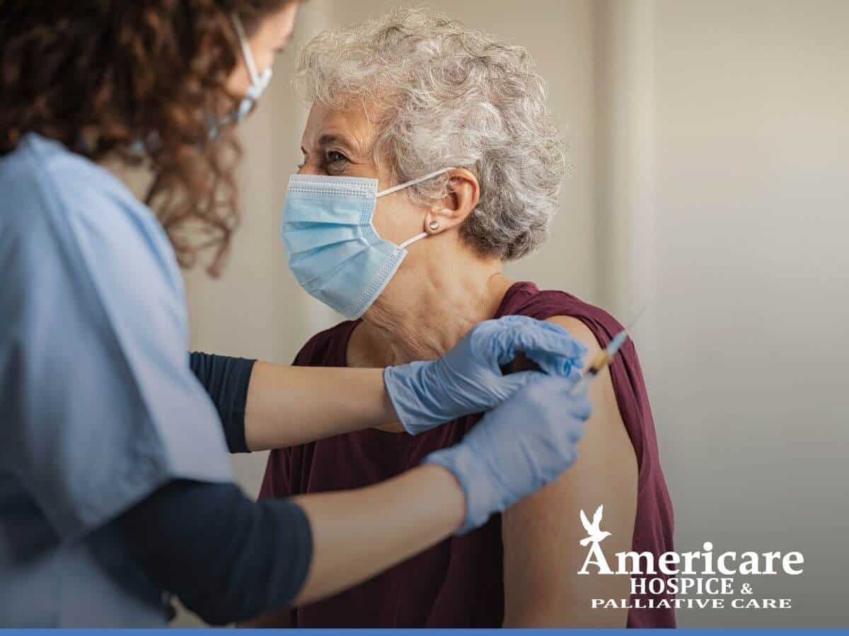 Nurse vaccinating an elderly woman against covid-19 at Americare Hospice Care